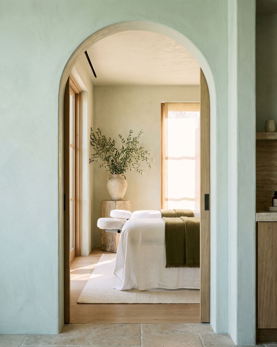 An arched doorway opening onto a calm treatment room