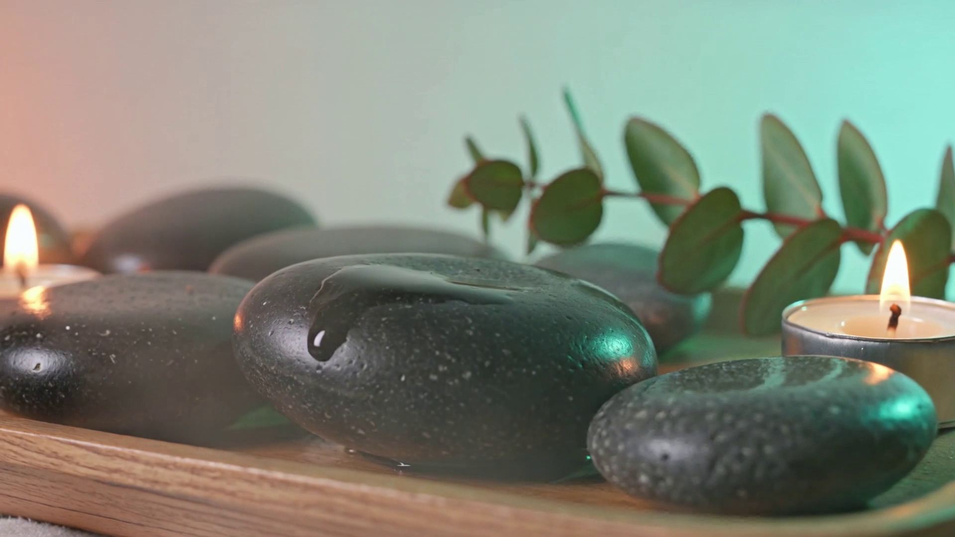 Hot stones, a candle and eucalyptus